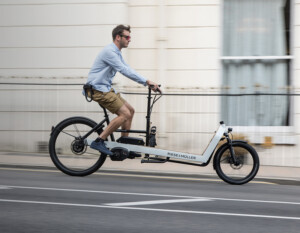 man riding cargo bike on a street with chain lock attached to bike with z lok